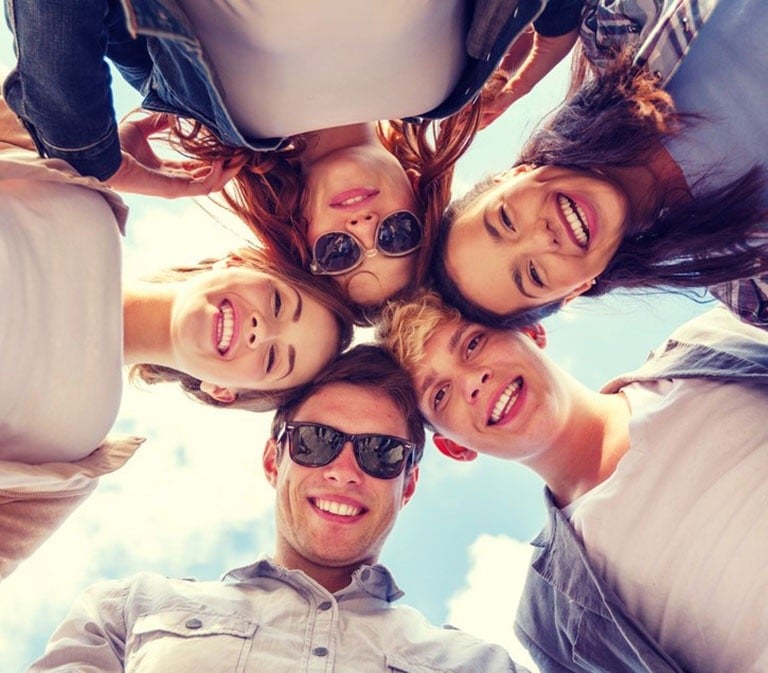 Group of people looking down at camera