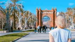Travellers walking towards Arc de Triomf in Barcelona, Spain