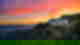 The Hollywood sign on the dry green hill with a beautiful pink and orange sunset over Los Angeles