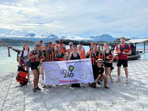 Travellers holding up a Gap 360 Thailand banner