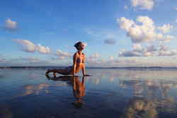 Girl on bali beach doing yoga