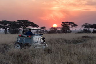 Safari truck at sunset in Africa