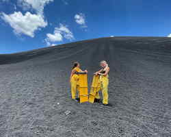 Travellers volcano boarding in Nicaragua
