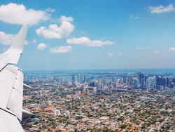 Plane wing view of city below