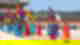 People dressed in colourful hanbok and waving traditional flags outside palace with crowd watching the ceremony