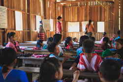 Volunteer teaching kids in classroom