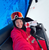 Group traveller holding travel gift voucher in Austria on ski lift