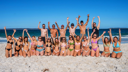 Group travellers on the beach in Australia on a Working Holiday Visa